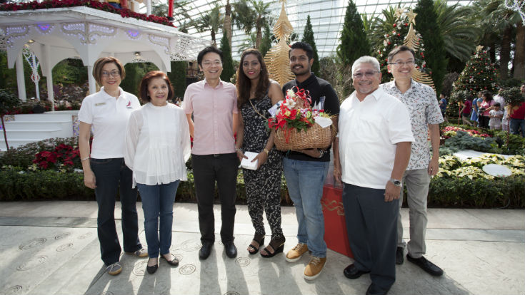 Gardens by the Bay Deputy CEO Ms Peggy Chong, Gardens by the Bay Chairman Mrs Theresa Foo, Minister for National Development Mr Lawrence Wong, 20-millionth visitor Miss Gowri d/o Subramanian and fiancé Mr Ramkumar Naidu s/o Thanabal Naidu, Gardens by the Bay CEO Dr Kiat W. Tan, and Gardens by the Bay COO Mr Felix Loh launch the “Christmas Toyland” floral display in the Flower Dome.