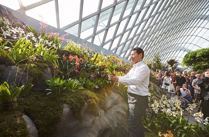 Minister Desmond Lee planting the final orchid at the launch of Orchids of the Andes.