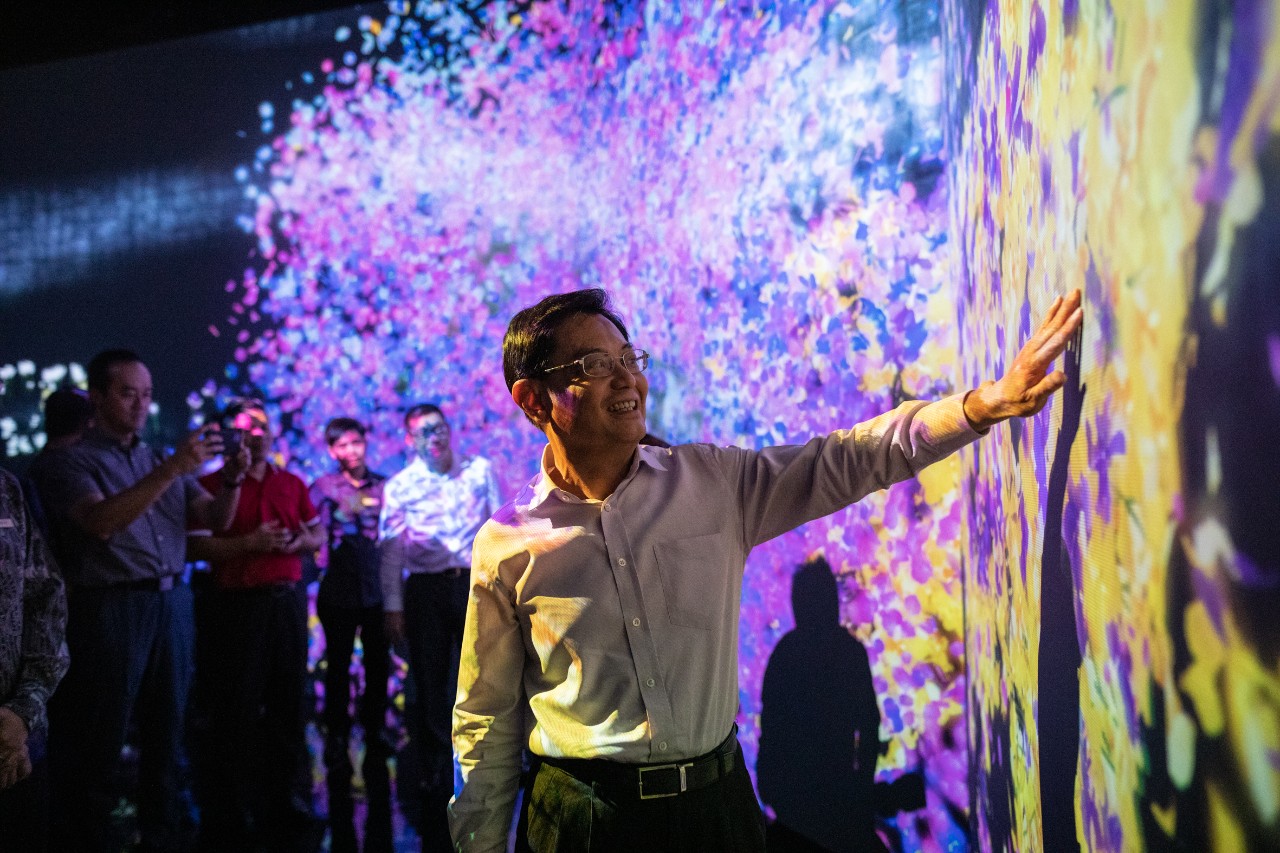 Deputy Prime Minister Heng Swee Keat interacting with the #futuretogether indoor exhibit, Animals of Flowers, Symbiotic Lives, which is one of the digital art installations that will open to public for the first time.