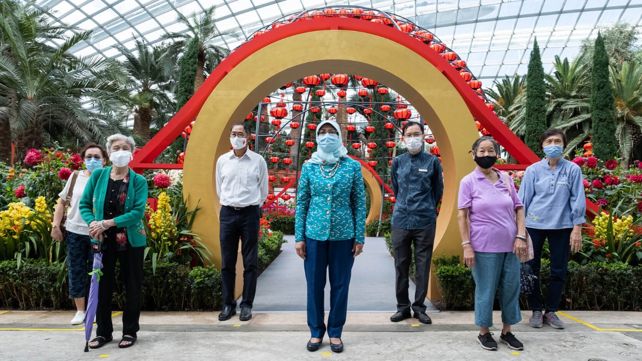 President Halimah Yacob (centre) with four beneficiaries from Concern & Care Society, along with Gardens by the Bay Chairman Mr Niam Chiang Meng (third from left) and Gardens by the Bay CEO Mr Felix Loh (fifth from left) at the Gardens’ Chinese New Year floral display Dahlia Dreams.