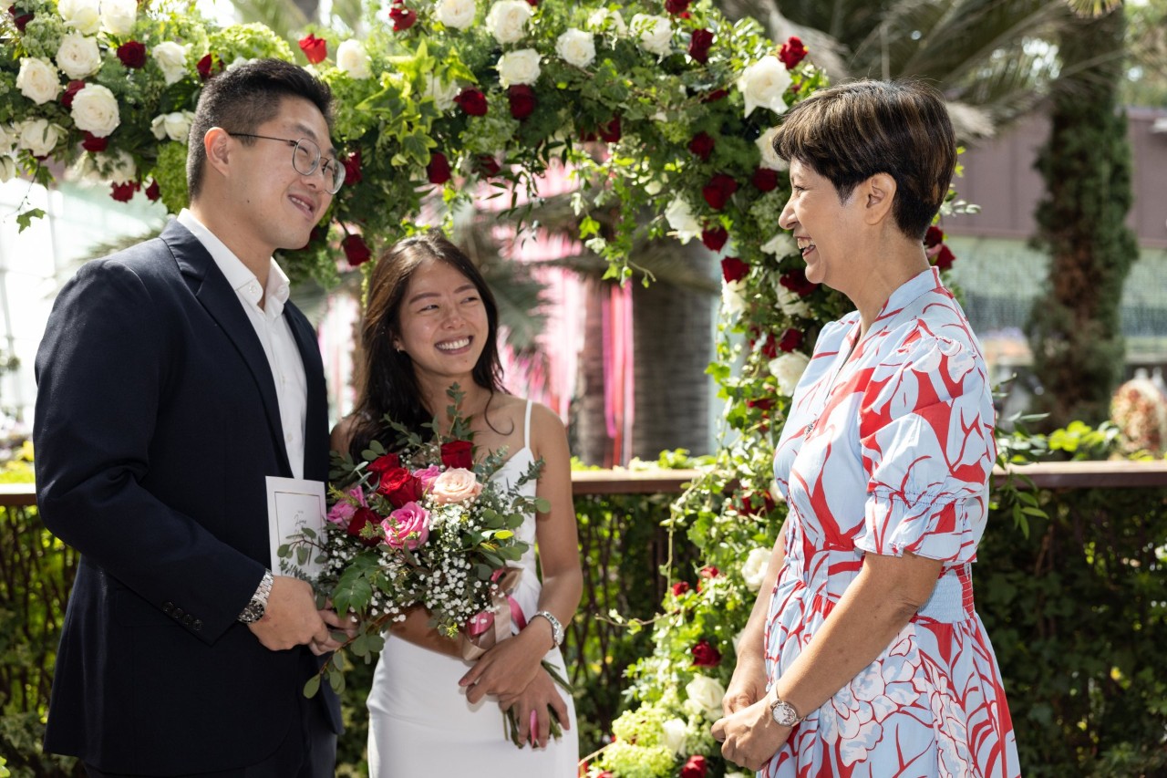 The first couple to solemnise their marriage at the Rose Romance floral display in Flower Dome, Lucas Tiong and Charlotte Ho, meet Minister in the Prime Minister's Office and Second Minister for Finance and National Development Indranee Rajah.