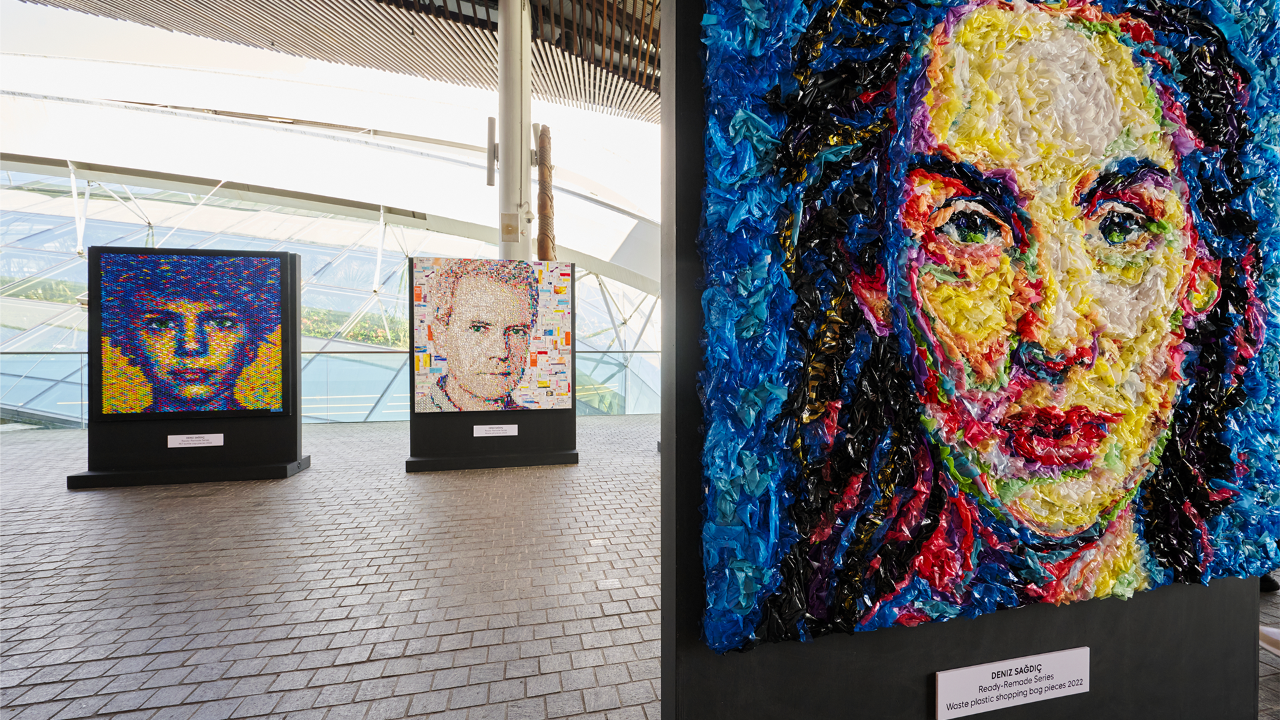 A portrait composed of plastic bags is among 14 portraits made of various waste materials in Turkish artist Deniz Sağdıç’s ongoing art exhibition outside Flower Dome. In the background is a portrait composed of plastic bottle caps (left) and one composed of medicinal pills and their packaging (right).