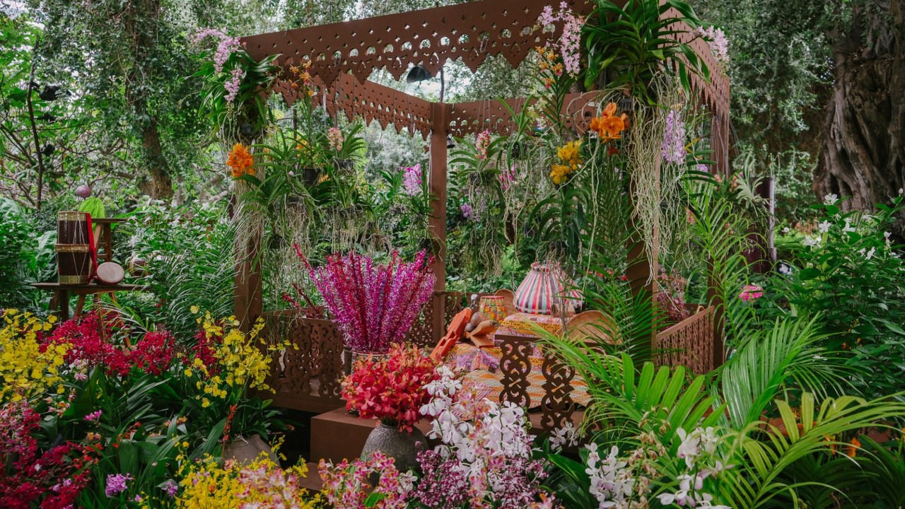 A plethora of colourful orchids surround a serambi 