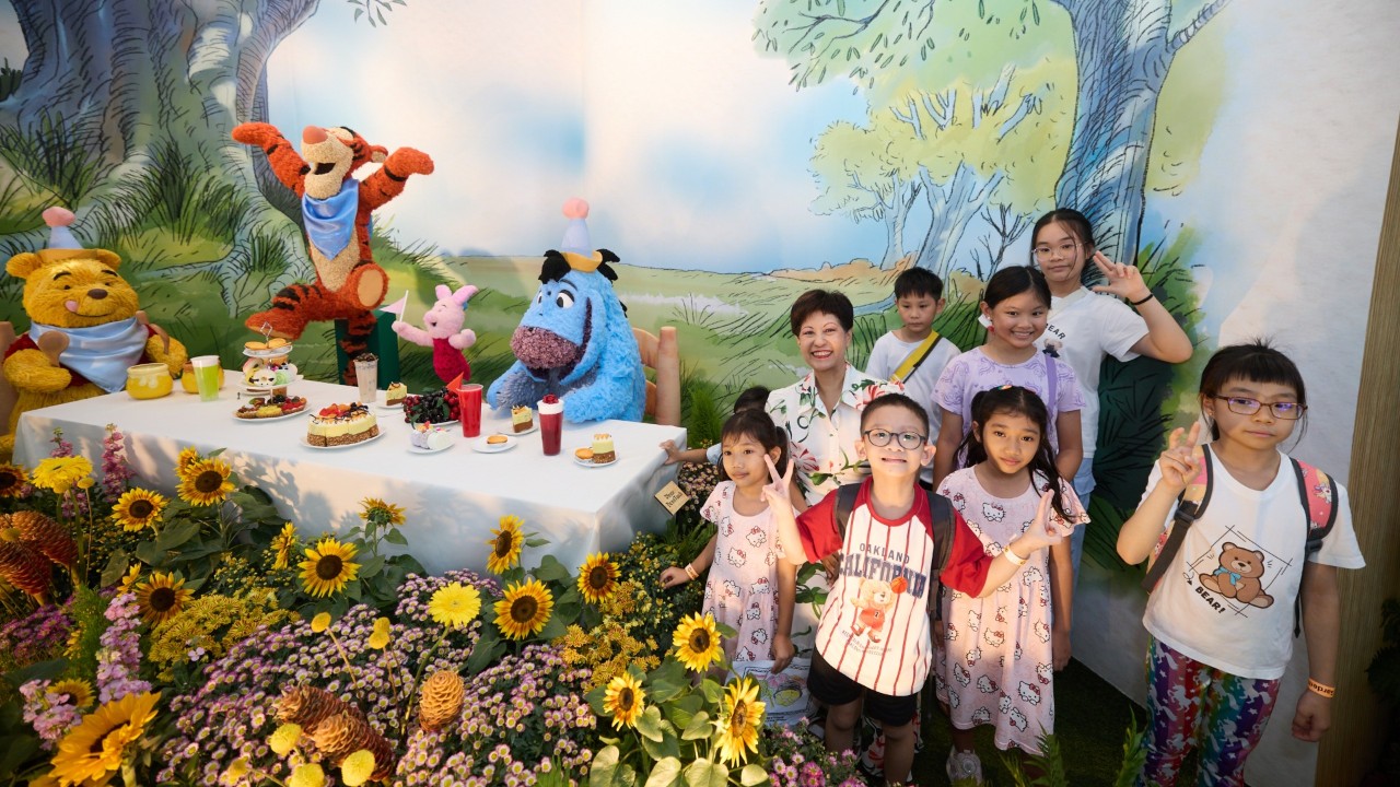 Minister in the Prime Minister’s Office and Second Minister for Finance and National Development Ms Indranee Rajah with children from Fei Yue Family Service Centre at the Disney Garden of Wonder topiary showcase.